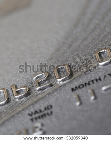 Closeup shot of a credit card. Numbers are partly shown. Validity partly visible.