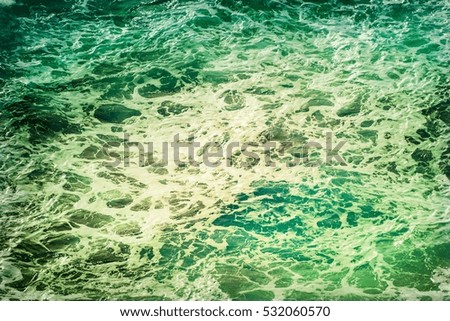 Atlantic ocean with turquoise blue water on a sunny day. Waves, foam, wake caused by cruise ship, color effect filtered image for tourism business concept, cruise sailing blogs, magazines websites
