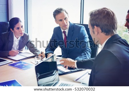 Business people interacting in conference room during meeting