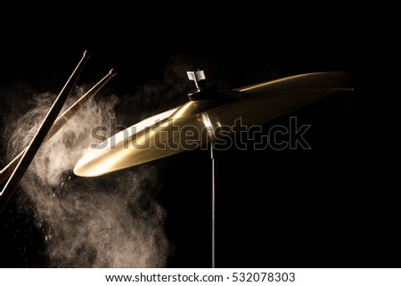 The drum stick hit on the crash cymbal 
in the  low key background Royalty-Free Stock Photo #532078303