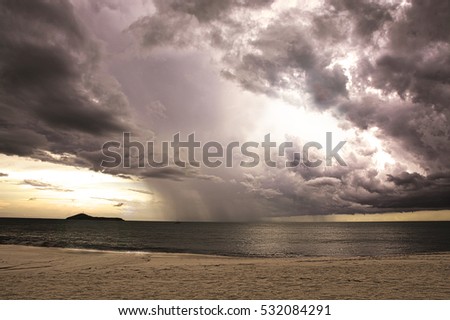 Dramatic stormy sky over the ocean on a lonely beach with a retro photography look