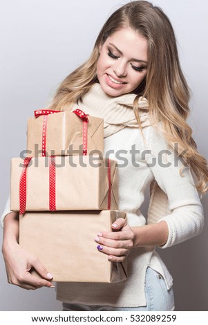 Young beautiful woman holding gifts. Happy girl holding gifts on white background. New Year. Christmas. Birthday.