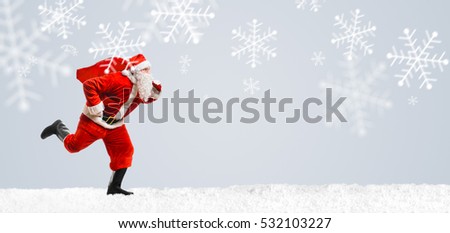 Santa Claus on scooter driving at Christmas or New Year snowy gray background