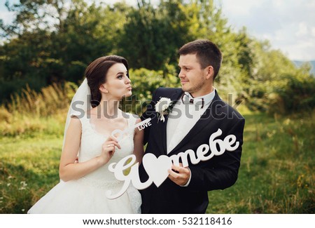 beautiful and young bride and groom having fun outdoors