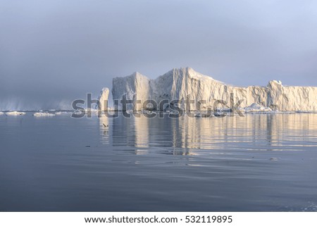 Coast of Greenland. View of the Glaciers and icebergs with summer midnight 