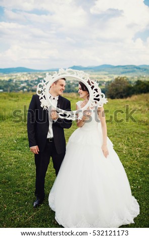 nice portrait of young and happy bride and groom in a frame
