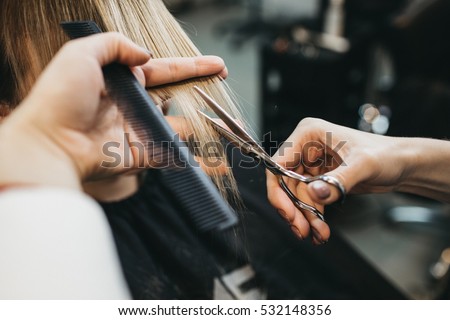 Scissors cut the girls hair Royalty-Free Stock Photo #532148356