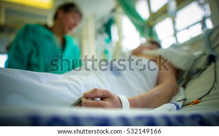 Doctor comforting a patient in an intensive care unit in a hospital Royalty-Free Stock Photo #532149166