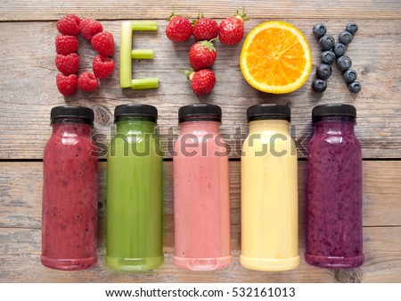 Assorted flavoured smoothie juices in bottles with detox spelt using fruits and vegetables  Royalty-Free Stock Photo #532161013