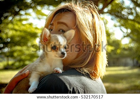 Woman with Chihuahua dog in the park