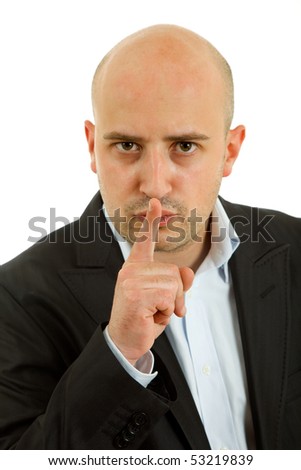 young man showing silence gesture with his finger in the mouth