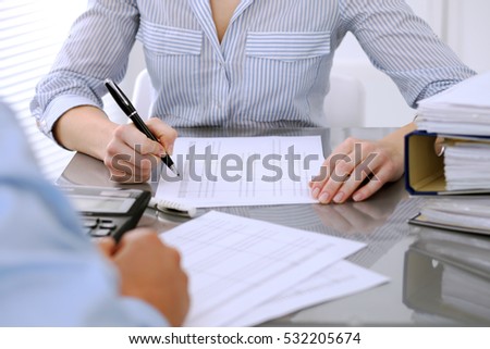 Bookkeepers or financial inspector making report, calculating or checking balance. Audit concept. 