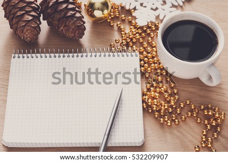 Christmas planning background. Prepare to winter holidays mockup. Top view flat lay of xmas decorations, note papers, pen, black coffee on wood. Copy space for wishlist or shedule