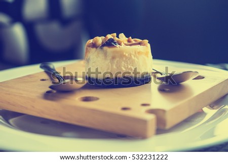it is almond cheese cake on wooden plate.