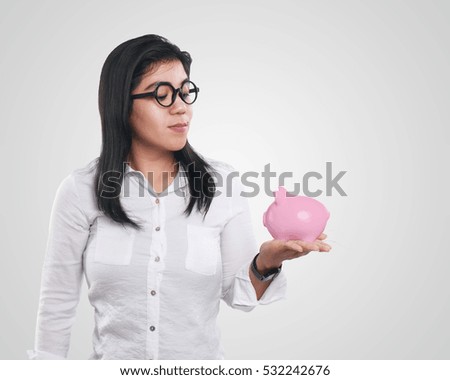 Photo image portrait of a beautiful young Asian businesswoman looked shocked while showing time on clock with both hands holding the clock over her head, half body close up portrait