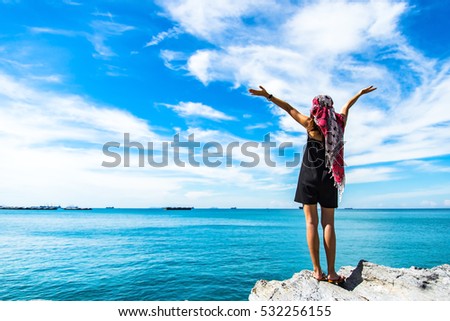 Traveler young women seeing the beautiful beach and blue sky, so happy and relax
