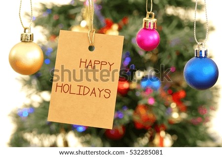 Happy Holidays - Message on the tag label with colorful decoration ball, the Christmas / new year / holiday concept