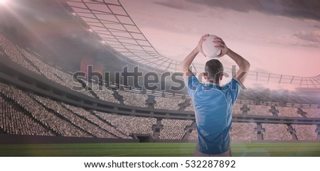 3D Rugby player holding a rugby ball against rugby stadium