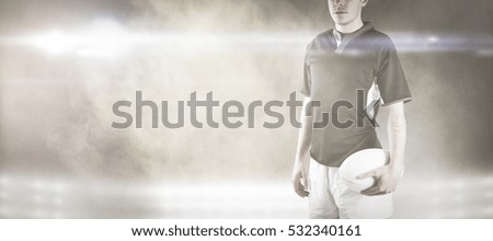 3D Frowning rugby player with arms crossed against splashing of yellow color powder