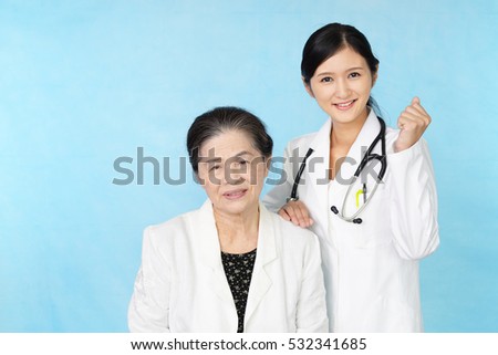 A friendly female doctor and an elderly woman