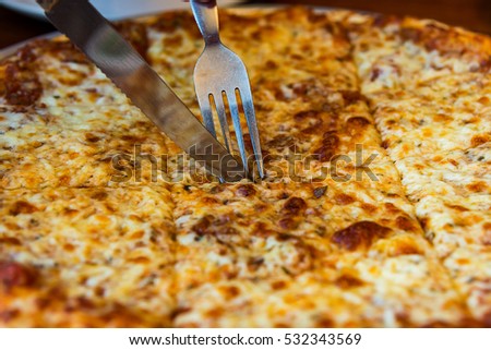 Classic Homemade Italian Cheese Pizza fresh out of the oven,Pizza quattro fromaggi on a steel tray,Hot four cheeses delicious rustic homemade american pizza with thick crust cheese pizza with fork 