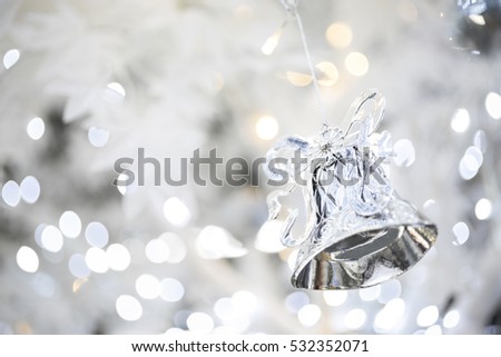Christmas tree background with white artificial maple and silver bell and gift box