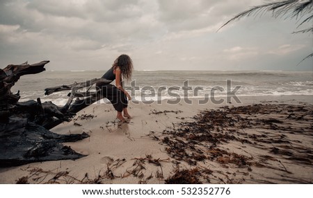 beautiful young woman on the beach. Stormy weather