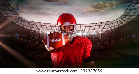 3D Portrait of american football player showing football to camera against red background with vignette
