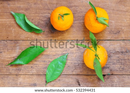 Close up of fresh mandarin oranges on a wooden table 