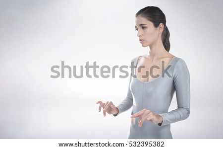 Thoughtful woman standing against white background against grey background