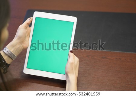 Young beautiful business woman holding tablet computer at office.