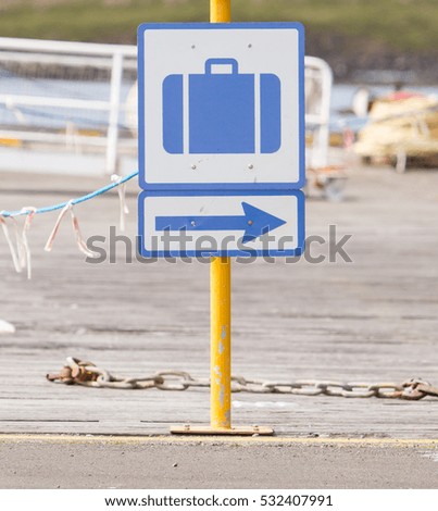Baggage sign on a yellow pole, harbour in Iceland