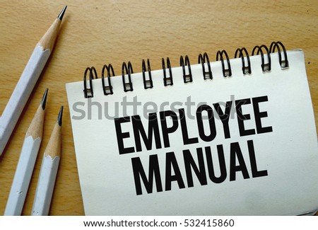 Employee Manual text written on a notebook with pencils