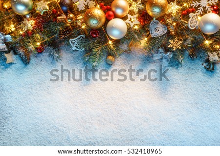 Christmas fir tree with decoration on snowy background. Merry Christmas and Happy New Year!! Top view. Royalty-Free Stock Photo #532418965
