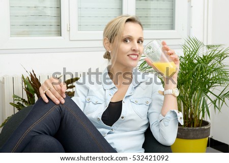 beautiful smiling blond woman drink orange juice 