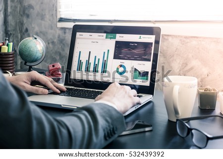 Close up of Businessman analyzing investment charts on the office desk. Royalty-Free Stock Photo #532439392