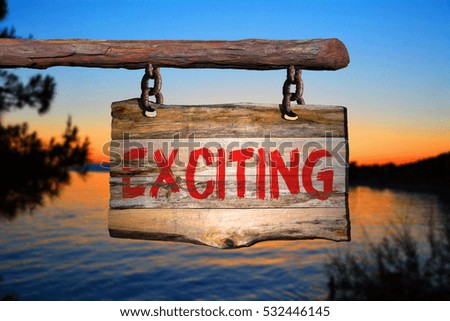 Exciting motivational phrase sign on old wood with blurred background