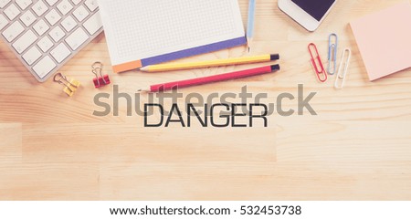 Business Workplace with  DANGER Concept on Wooden Background