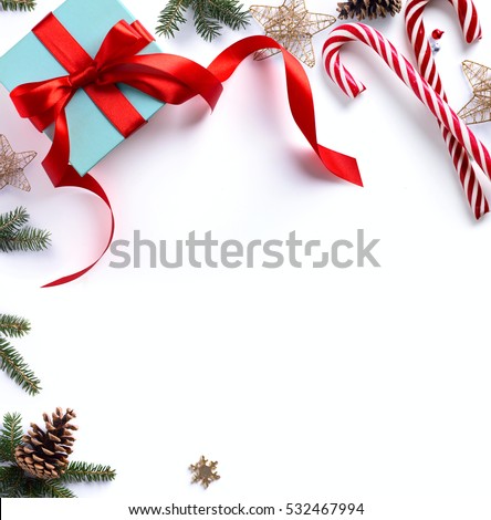 Christmas gift, fir tree branches and Christmas ornament on white background. Flat lay, top view.
