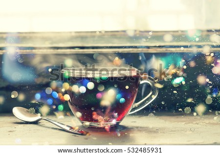 tea. Winter time. Tinted picture. A cup of hot tea at the window. Autumn time. New Year, falling snow, gold tinsel