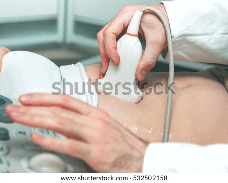 Doctor with ultrasound scan woman belly