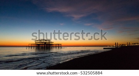 West pier remains at sunset, Brighton and Hove beach, East Sussex, England, United Kingdom Royalty-Free Stock Photo #532505884