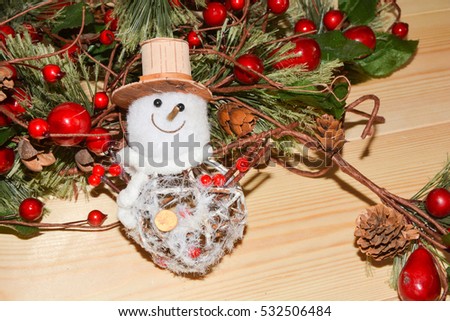 Christmas Snowman with fir branches with red berries.