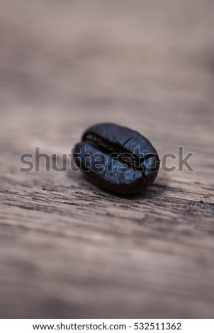 Close up of coffee beans over wood background.