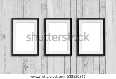 Black natural wooden frames, on old painted panels wall. Retro style design, gallery decor mock up Royalty-Free Stock Photo #532520266