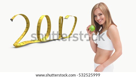 3D Portrait of happy young woman holding green apple against 2017 made of measuring tape