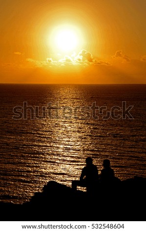 Silohuetted People over a Sunset in the Atlantic Ocean, in Canary Islands, Spain