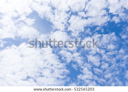white fluffy clouds in the blue sky.