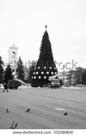 montage of main Christmas tree in town square, Brest, Belarus,winter cityscape bw