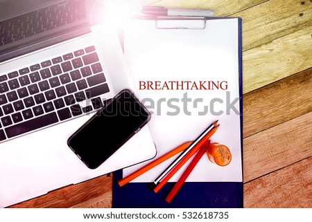  BREATHTAKING text write at notepad in wooden background